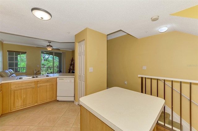 kitchen with dishwasher, light tile patterned floors, a sink, crown molding, and a textured ceiling