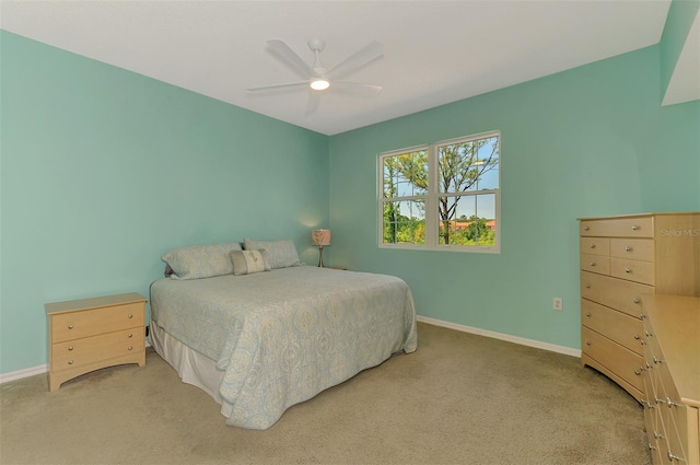 bedroom featuring ceiling fan, baseboards, and light colored carpet