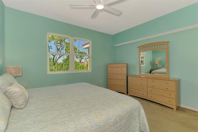 bedroom with a ceiling fan and carpet
