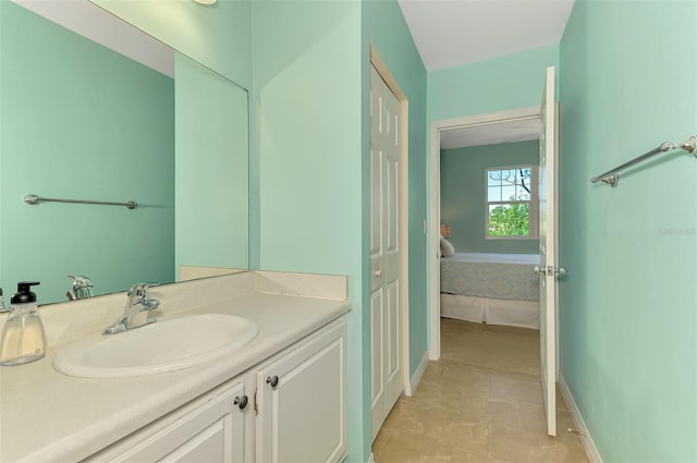 bathroom with baseboards and vanity
