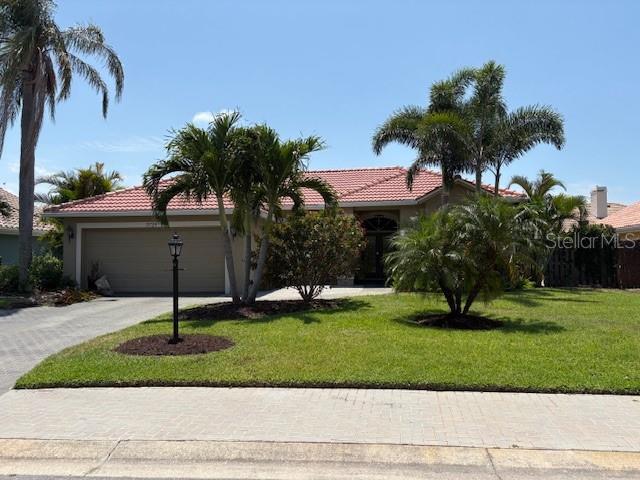 mediterranean / spanish-style house featuring driveway, stucco siding, a garage, and a tile roof