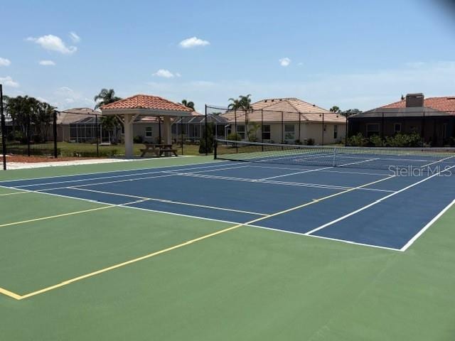view of sport court featuring fence and a gazebo