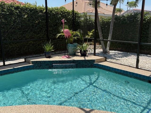 view of swimming pool with a lanai and a fenced in pool