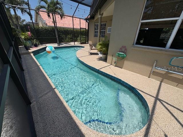 view of pool featuring a patio area, a fenced in pool, and a lanai