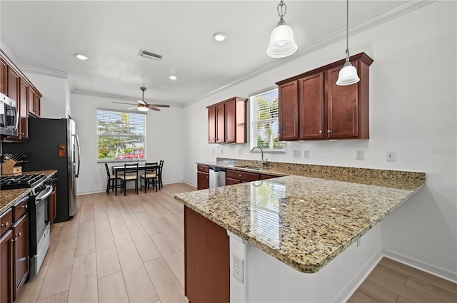 kitchen with ornamental molding, a ceiling fan, visible vents, stainless steel appliances, and a sink
