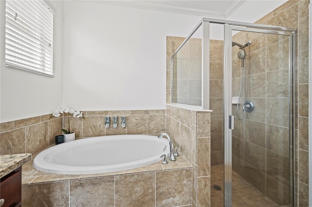 bathroom featuring vanity, a garden tub, crown molding, and a stall shower