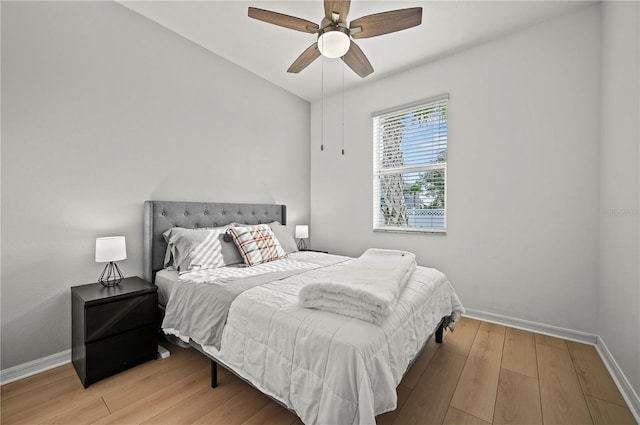 bedroom featuring baseboards, a ceiling fan, and wood finished floors