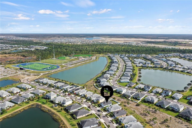 birds eye view of property with a water view and a residential view