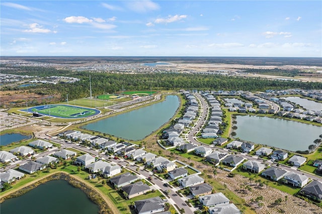 drone / aerial view featuring a water view and a residential view