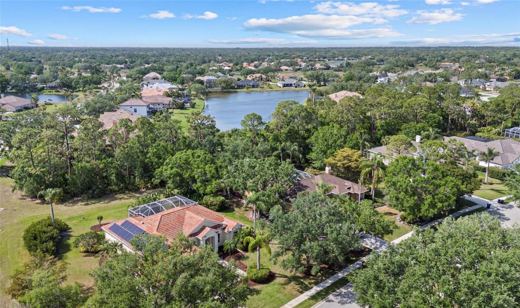 drone / aerial view with a water view and a residential view