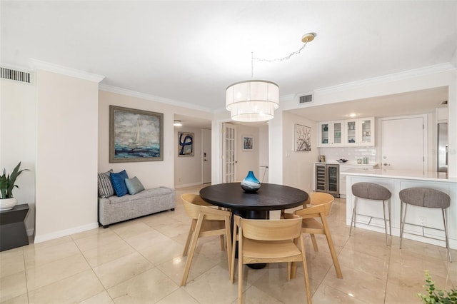 1750 Benjamin Franklin Dr Unit 6B, Sarasota, FL 34236 - dining room with beverage cooler, ornamental molding, bar area, and light tile patterned floors
