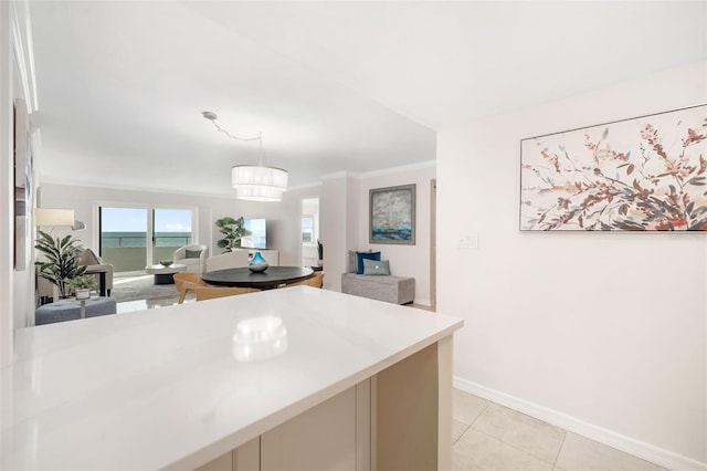 1750 Benjamin Franklin Dr Unit 6B, Sarasota, FL 34236 - kitchen with light countertops, open floor plan, decorative light fixtures, ornamental molding, and light tile patterned floors