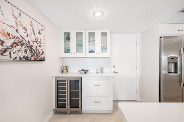 1750 Benjamin Franklin Dr Unit 6B, Sarasota, FL 34236 - indoor dry bar featuring stainless steel refrigerator with ice dispenser, beverage cooler, and light tile patterned flooring