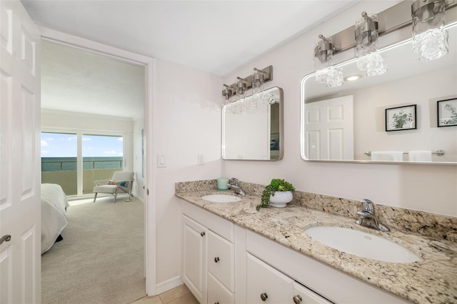 1750 Benjamin Franklin Dr Unit 6B, Sarasota, FL 34236 - bathroom featuring double vanity and baseboards