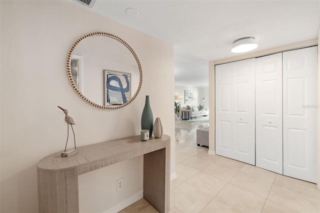 1750 Benjamin Franklin Dr Unit 6B, Sarasota, FL 34236 - corridor with light tile patterned floors and a desk
