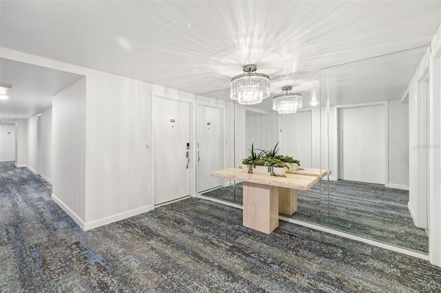 1750 Benjamin Franklin Dr Unit 6B, Sarasota, FL 34236 - mudroom featuring a chandelier and dark carpet