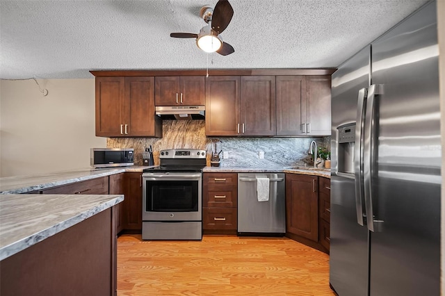 6033 34th St W Unit 132, Bradenton, FL 34210 - kitchen featuring stainless steel appliances, under cabinet range hood, a textured ceiling, a ceiling fan, and a sink