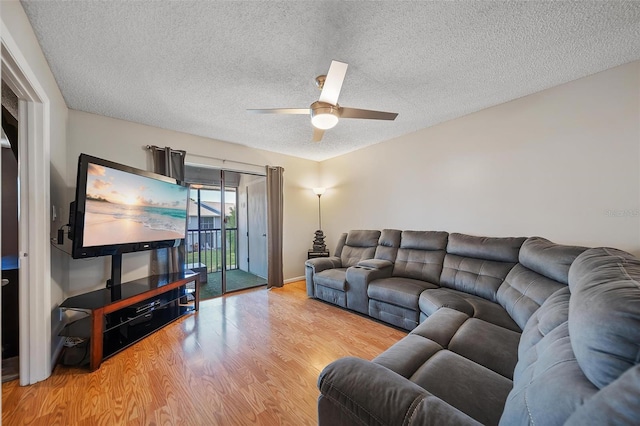 6033 34th St W Unit 132, Bradenton, FL 34210 - living room featuring light wood-type flooring, a ceiling fan, a textured ceiling, and baseboards
