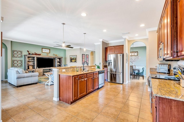 6729 45th Ter E, Bradenton, FL 34203 - kitchen with open floor plan, arched walkways, appliances with stainless steel finishes, and ceiling fan