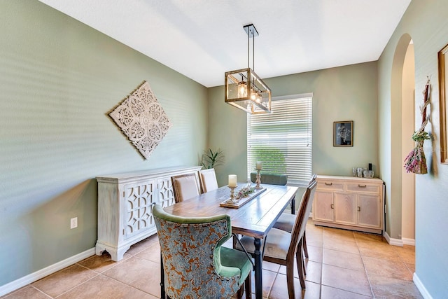 6729 45th Ter E, Bradenton, FL 34203 - dining area featuring a chandelier, baseboards, arched walkways, and light tile patterned flooring