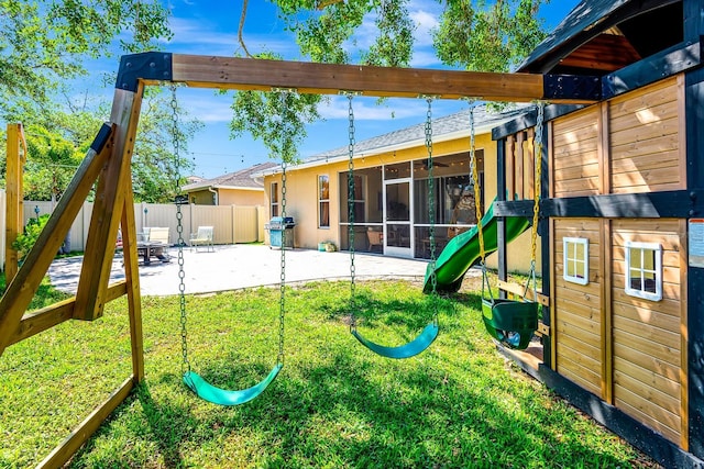 6729 45th Ter E, Bradenton, FL 34203 - view of playground featuring a patio area, fence, a sunroom, and a lawn