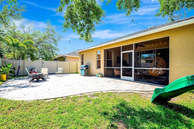 6729 45th Ter E, Bradenton, FL 34203 - back of house with a sunroom, a patio area, stucco siding, and fence
