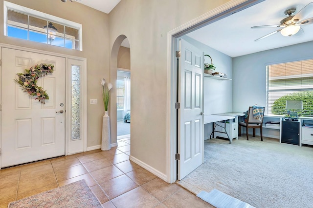 6729 45th Ter E, Bradenton, FL 34203 - foyer entrance featuring light tile patterned floors, a ceiling fan, arched walkways, and a healthy amount of sunlight