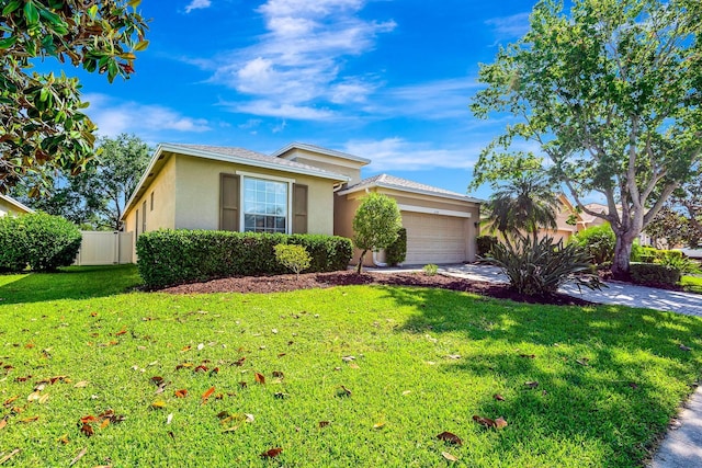 6729 45th Ter E, Bradenton, FL 34203 - ranch-style house featuring concrete driveway, stucco siding, a front lawn, a garage, and fence