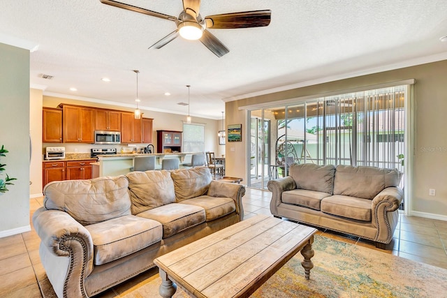 6729 45th Ter E, Bradenton, FL 34203 - living room featuring light tile patterned flooring, ceiling fan, ornamental molding, and baseboards