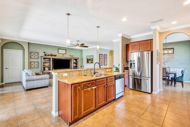 6729 45th Ter E, Bradenton, FL 34203 - kitchen with arched walkways, a sink, open floor plan, crown molding, and stainless steel appliances
