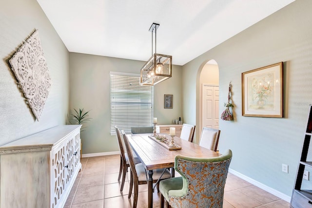 6729 45th Ter E, Bradenton, FL 34203 - dining room with a chandelier, arched walkways, light tile patterned floors, and baseboards