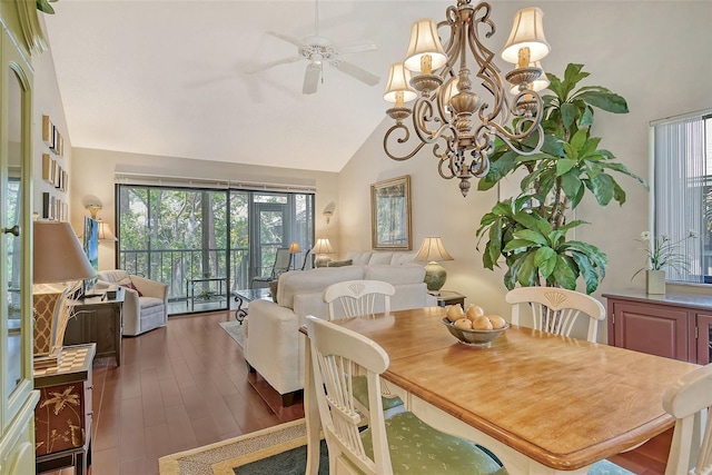 dining space with high vaulted ceiling, wood finished floors, and ceiling fan with notable chandelier