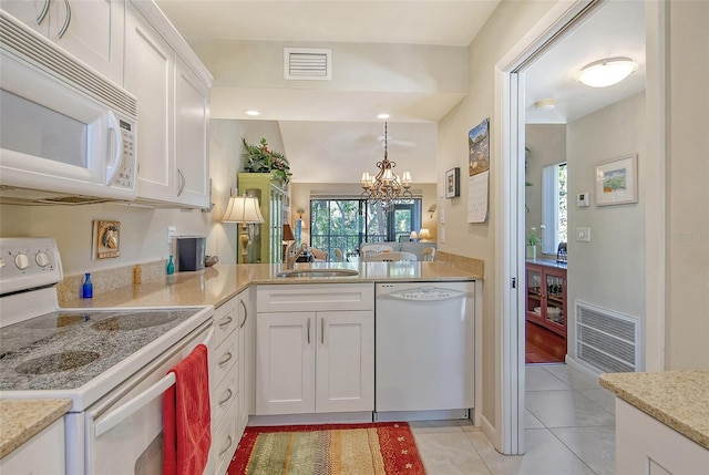 kitchen featuring a notable chandelier, visible vents, a sink, and white appliances