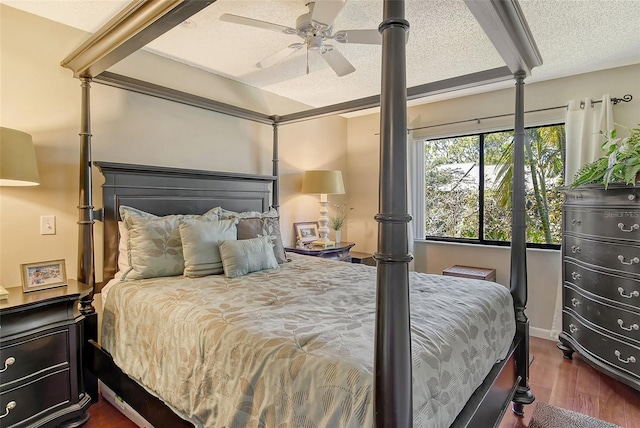 bedroom featuring a ceiling fan, dark wood-style flooring, and a textured ceiling