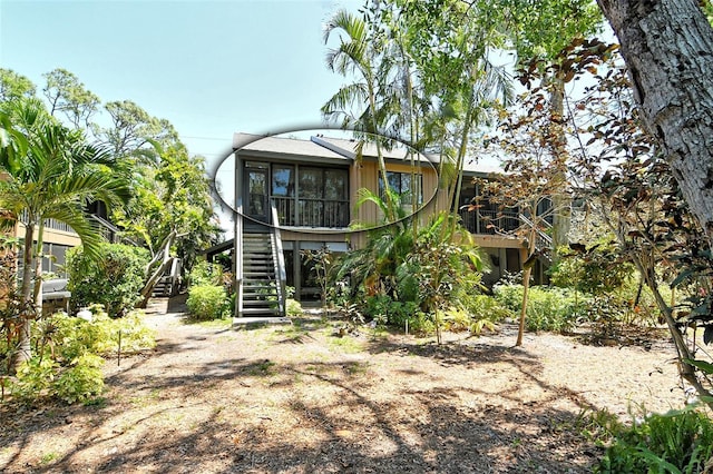 rear view of property with stairs