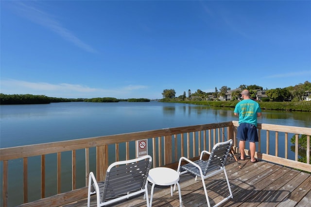 wooden terrace featuring a water view