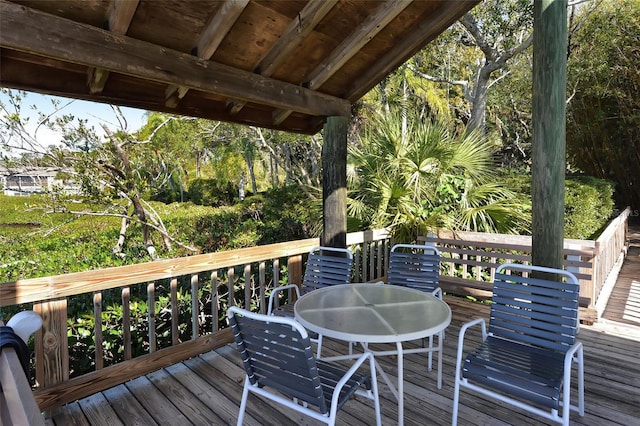 wooden terrace featuring outdoor dining area