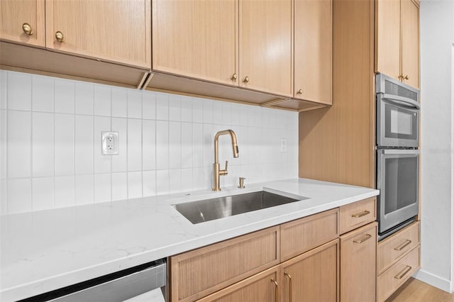 1050 55th Ave S, Saint Petersburg, FL 33705 - kitchen featuring a sink, backsplash, stainless steel appliances, light stone counters, and light brown cabinets