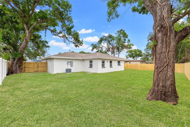 1050 55th Ave S, Saint Petersburg, FL 33705 - back of property featuring stucco siding and central air condition unit