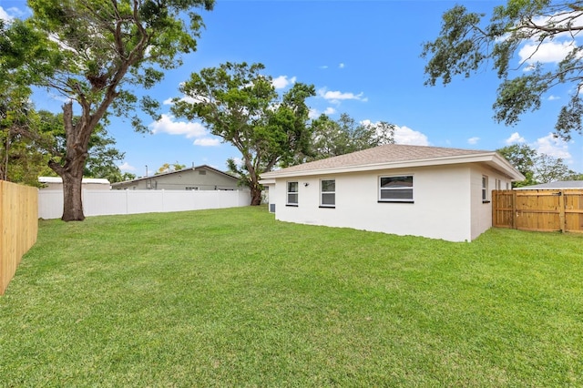 1050 55th Ave S, Saint Petersburg, FL 33705 - rear view of property featuring stucco siding and roof with shingles