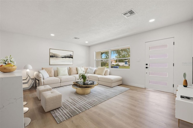 1050 55th Ave S, Saint Petersburg, FL 33705 - living room with wood finished floors, recessed lighting, a textured ceiling, and baseboards