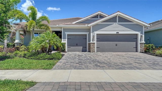 5793 Long Shore Loop, Sarasota, FL 34238 - view of front of home featuring a garage, stone siding, and decorative driveway