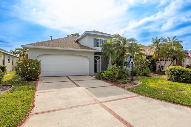 1322 Millbrook Cir, Bradenton, FL 34212 - view of front of property with roof with shingles, concrete driveway, an attached garage, a front yard, and stucco siding