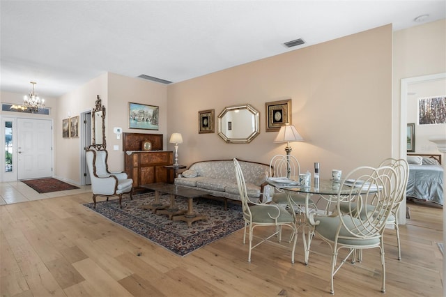 1322 Millbrook Cir, Bradenton, FL 34212 - living area featuring an inviting chandelier, wood finished floors, visible vents, and baseboards