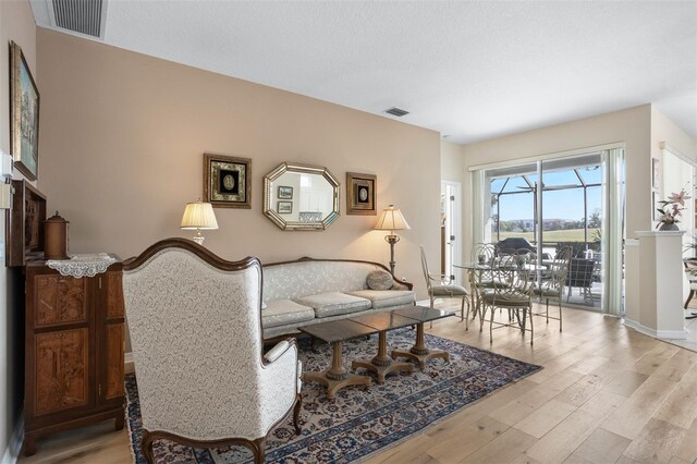1322 Millbrook Cir, Bradenton, FL 34212 - living area with light wood-style flooring, visible vents, and baseboards