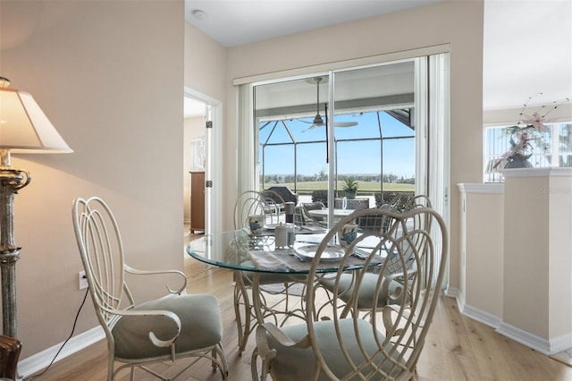 1322 Millbrook Cir, Bradenton, FL 34212 - dining area with baseboards, a ceiling fan, a sunroom, and light wood finished floors