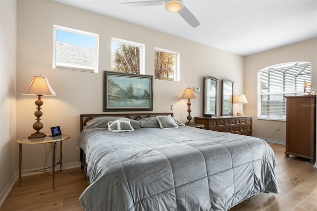 1322 Millbrook Cir, Bradenton, FL 34212 - bedroom featuring ceiling fan, light wood-style flooring, baseboards, and multiple windows