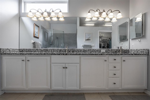 1322 Millbrook Cir, Bradenton, FL 34212 - bathroom with double vanity, a shower stall, tile patterned floors, and a sink