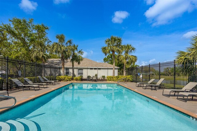 1322 Millbrook Cir, Bradenton, FL 34212 - community pool featuring a patio and fence