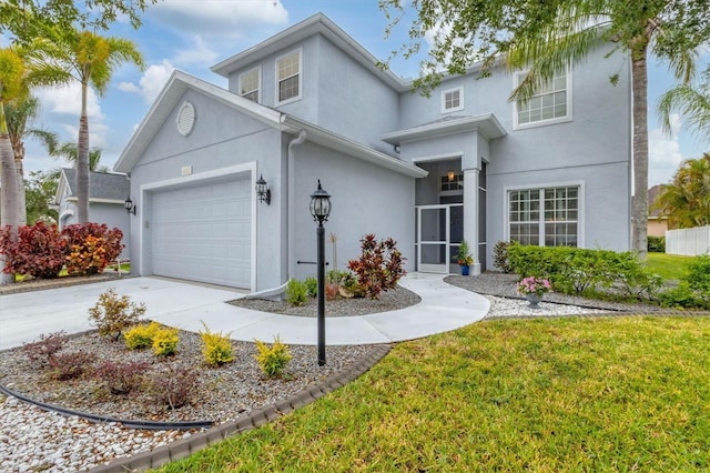 traditional-style home featuring an attached garage, driveway, stucco siding, and a front lawn